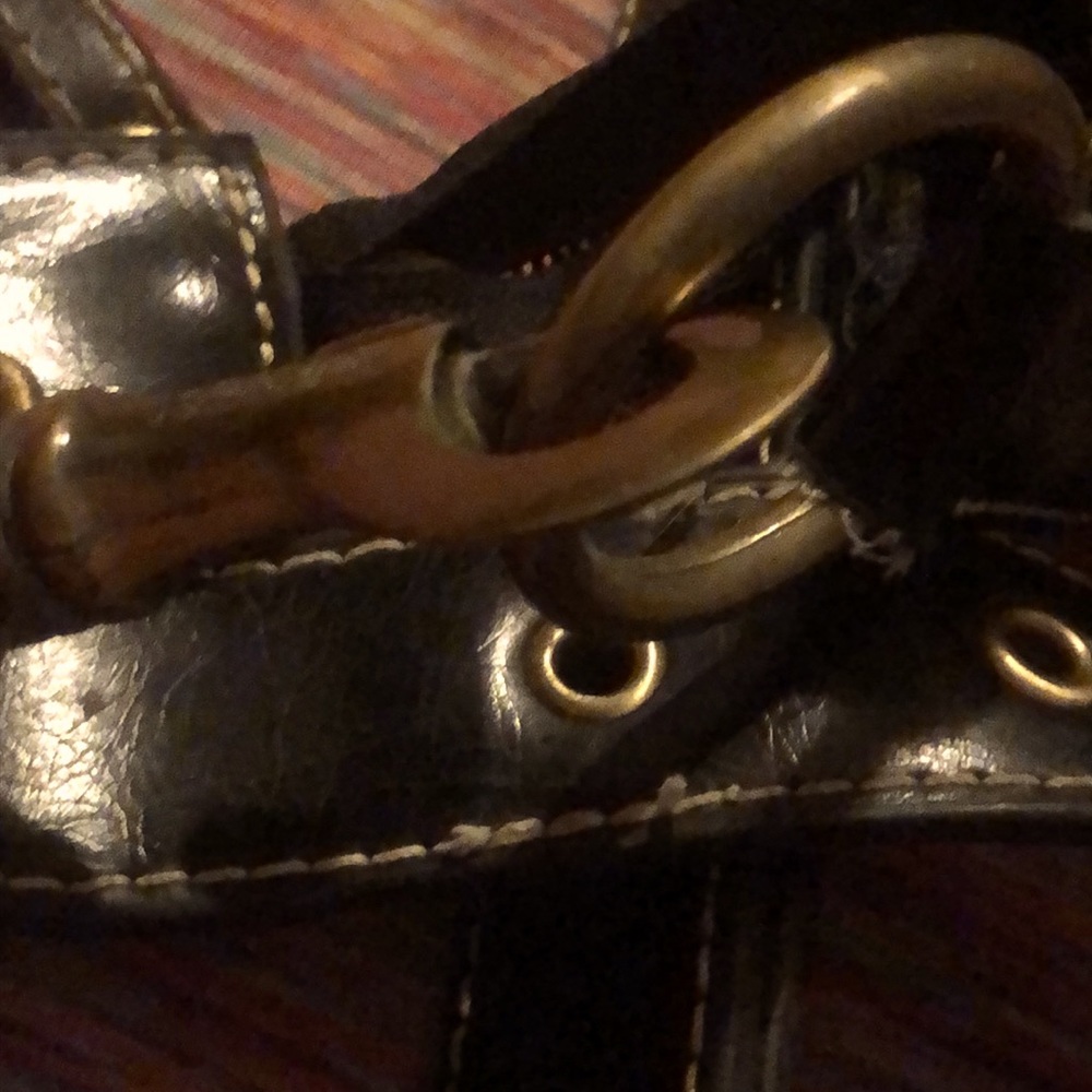 A very loved black coach purse .